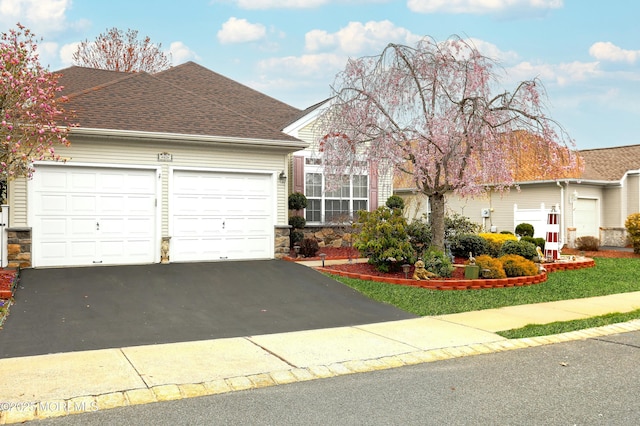 40 Isabella Dr, Manchester, NJ 08759 - view of front of house featuring an attached garage, a shingled roof, stone siding, and aphalt driveway