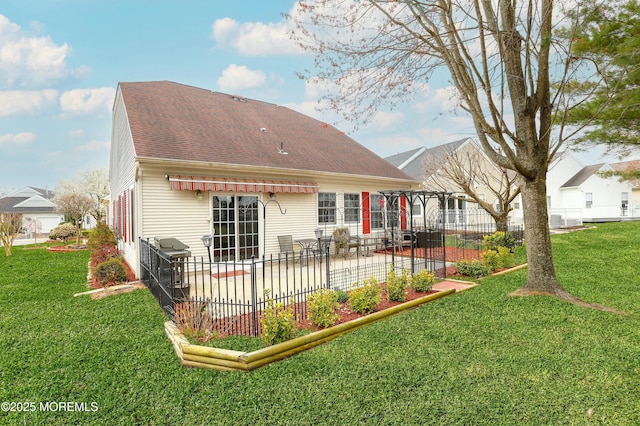 40 Isabella Dr, Manchester, NJ 08759 - back of house featuring a shingled roof, a patio area, fence, and a lawn