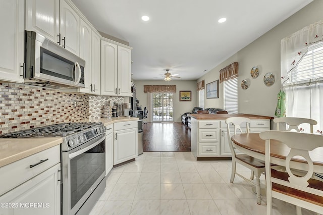 40 Isabella Dr, Manchester, NJ 08759 - kitchen featuring tasteful backsplash, light countertops, white cabinetry, and stainless steel appliances