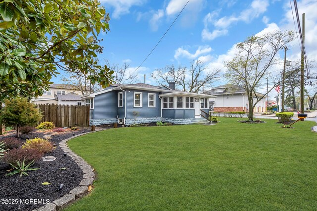 6 Beachwood Blvd, Beachwood, NJ 08722 - back of house featuring fence, a yard, a sunroom, and a chimney