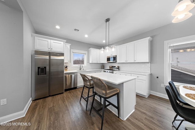 211 Pine Dr, Bayville, NJ 08721 - kitchen with stainless steel appliances, white cabinetry, a sink, and backsplash