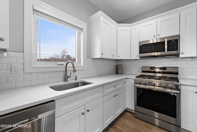 211 Pine Dr, Bayville, NJ 08721 - kitchen featuring tasteful backsplash, white cabinets, light countertops, a sink, and stainless steel appliances