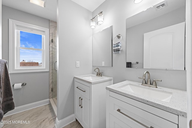 211 Pine Dr, Bayville, NJ 08721 - full bathroom with two vanities, marble finish floor, a sink, and a stall shower