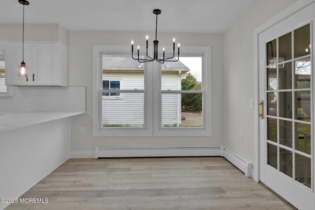 101 Torrey Pines Dr, Toms River, NJ 08757 - unfurnished dining area featuring a baseboard radiator, a notable chandelier, and light wood-style floors