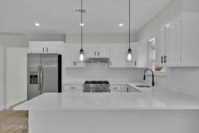 101 Torrey Pines Dr, Toms River, NJ 08757 - kitchen featuring stainless steel fridge with ice dispenser, visible vents, a sink, under cabinet range hood, and range