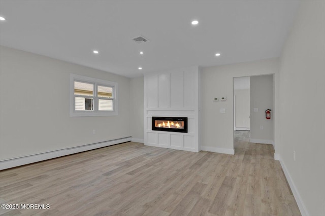 101 Torrey Pines Dr, Toms River, NJ 08757 - unfurnished living room with light wood-style floors, a baseboard heating unit, a large fireplace, and recessed lighting