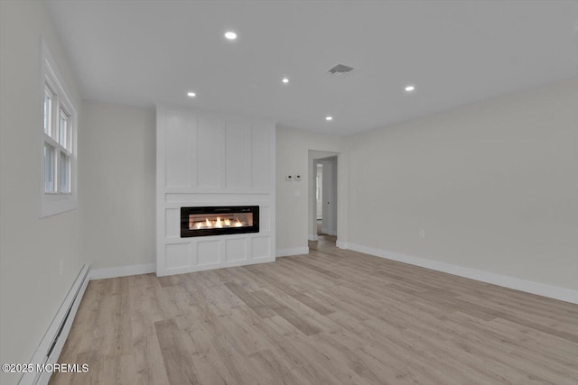 101 Torrey Pines Dr, Toms River, NJ 08757 - unfurnished living room with baseboard heating, a fireplace, recessed lighting, light wood-style floors, and visible vents