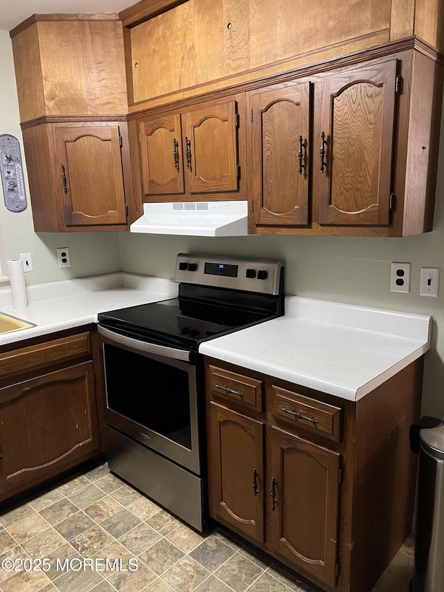 10 Homestead Dr Unit C, Whiting, NJ 08759 - kitchen with stainless steel electric range, a sink, light countertops, and ventilation hood