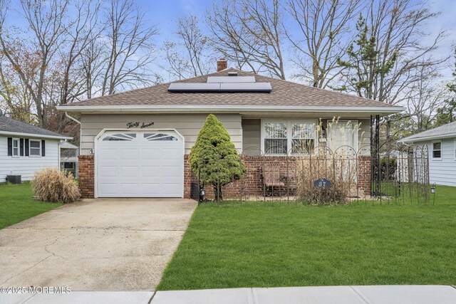 37 Scarborough Pl, Toms River, NJ 08757 - view of front of house featuring solar panels, concrete driveway, brick siding, a front lawn, and roof with shingles