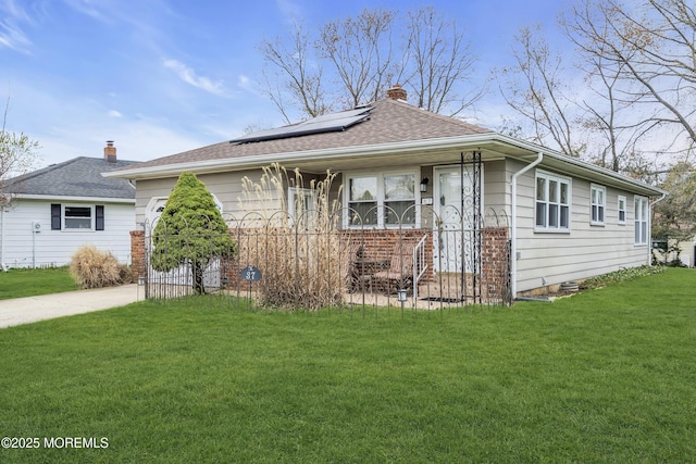 37 Scarborough Pl, Toms River, NJ 08757 - view of front of property with roof mounted solar panels, driveway, a front yard, and a chimney