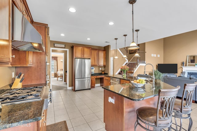 41 Hedgerow Ln, Manalapan, NJ 07726 - kitchen with brown cabinets, exhaust hood, stainless steel appliances, light tile patterned flooring, and a breakfast bar area
