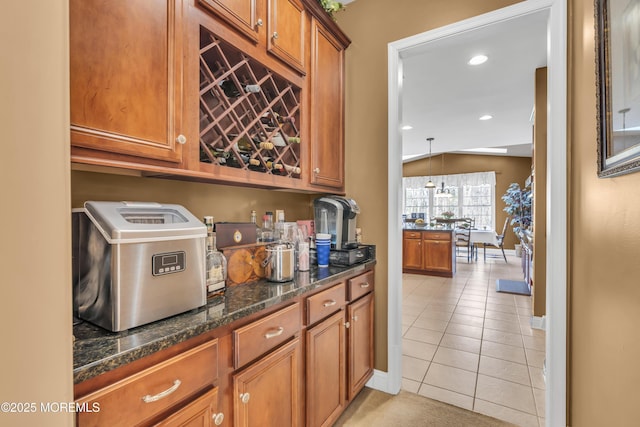 41 Hedgerow Ln, Manalapan, NJ 07726 - kitchen with dark stone countertops, brown cabinets, light tile patterned floors, baseboards, and recessed lighting