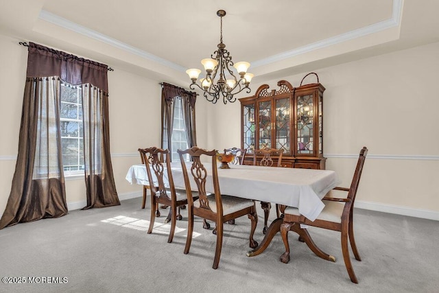 41 Hedgerow Ln, Manalapan, NJ 07726 - carpeted dining space featuring a tray ceiling, baseboards, ornamental molding, and an inviting chandelier