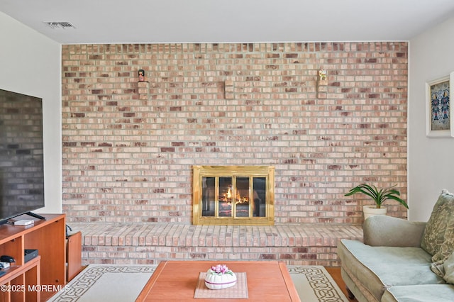living area with a fireplace and visible vents
