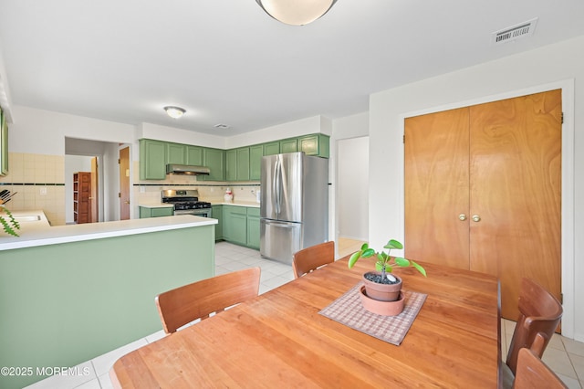 dining space featuring visible vents and light tile patterned floors