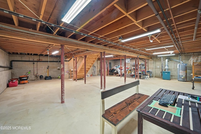 unfinished basement with gas water heater and stairway