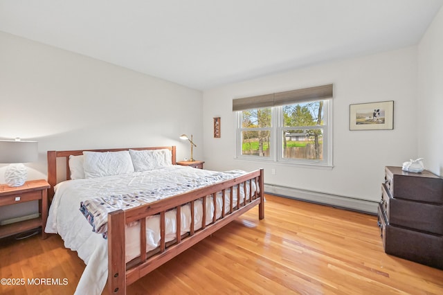 bedroom featuring a baseboard radiator and light wood-type flooring