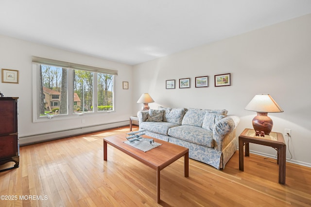 living area featuring a baseboard radiator and wood finished floors