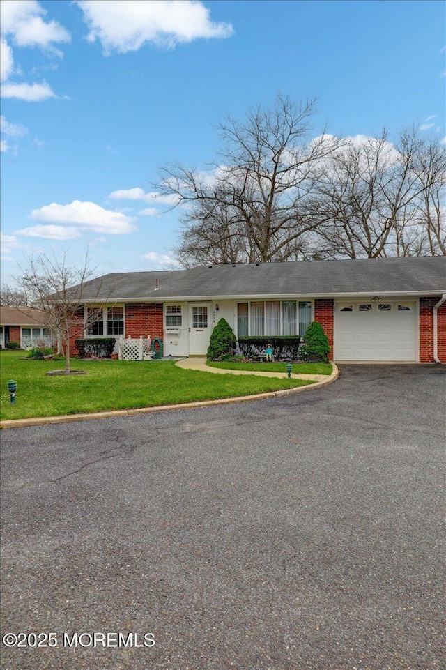 455B Portsmouth Dr, Lakewood, NJ 08701 - ranch-style house featuring brick siding, aphalt driveway, an attached garage, and a front lawn