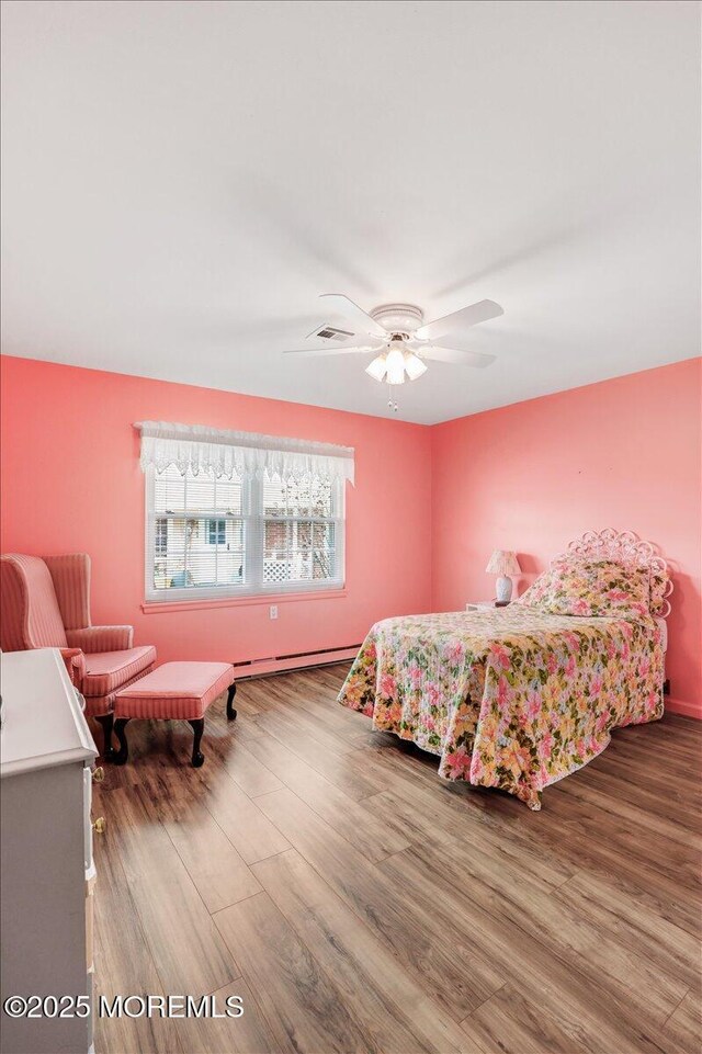 455B Portsmouth Dr, Lakewood, NJ 08701 - bedroom with a baseboard heating unit, a ceiling fan, and wood finished floors
