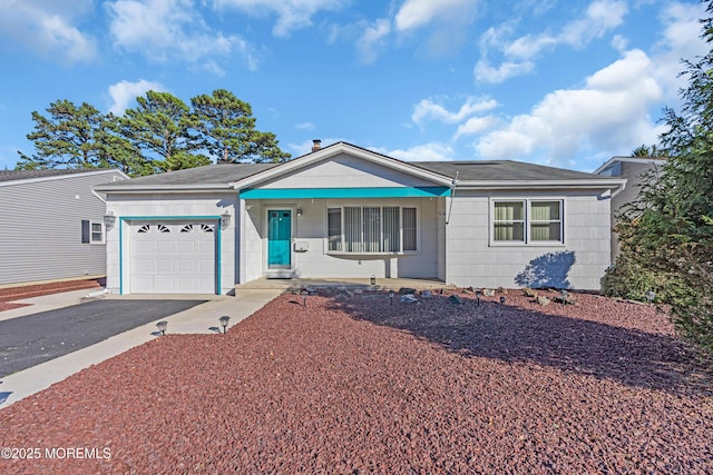 ranch-style home with a garage, driveway, and a porch