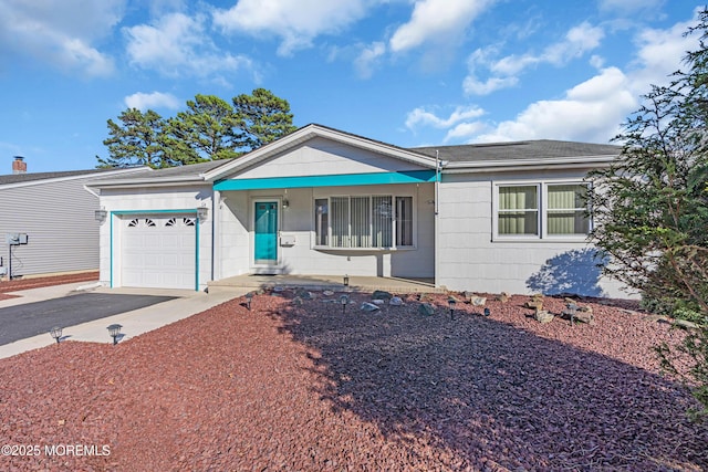 ranch-style home with aphalt driveway, covered porch, and a garage