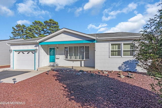 ranch-style home featuring driveway and a garage