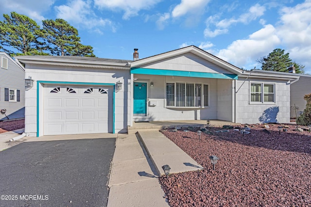 single story home featuring a garage and driveway