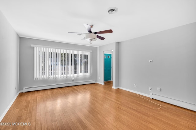 empty room with light wood finished floors, visible vents, a ceiling fan, a baseboard heating unit, and baseboard heating