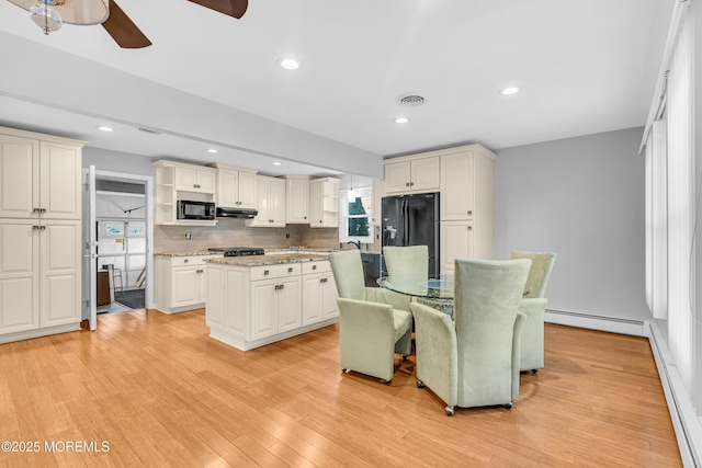 dining area featuring recessed lighting, visible vents, a ceiling fan, a baseboard heating unit, and light wood-type flooring
