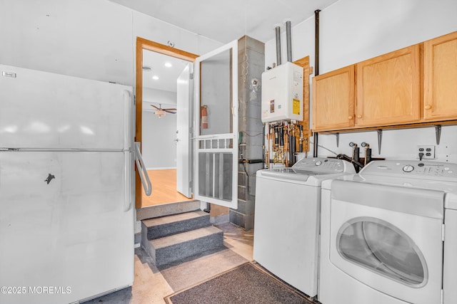 laundry room with tankless water heater, ceiling fan, cabinet space, and washer and clothes dryer
