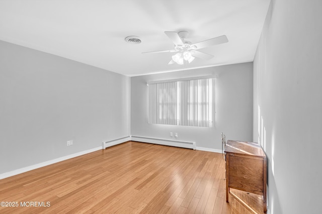 unfurnished room with a baseboard heating unit, baseboards, visible vents, light wood-style floors, and ceiling fan