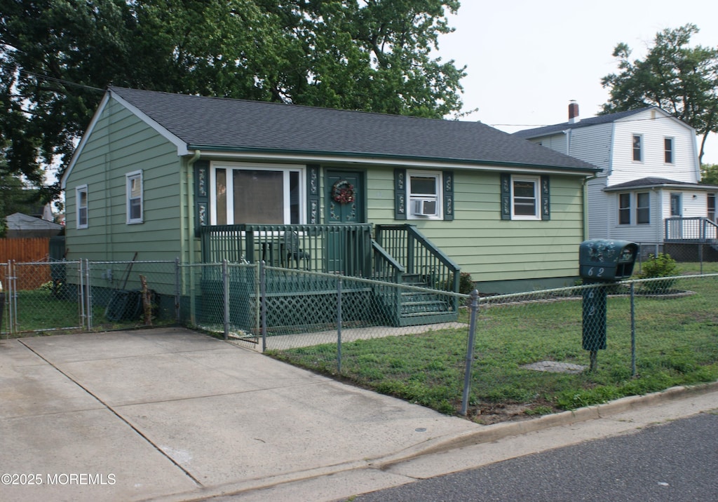 62 Roland St, Keansburg, NJ 07734 - view of front of house with a fenced front yard, cooling unit, and roof with shingles