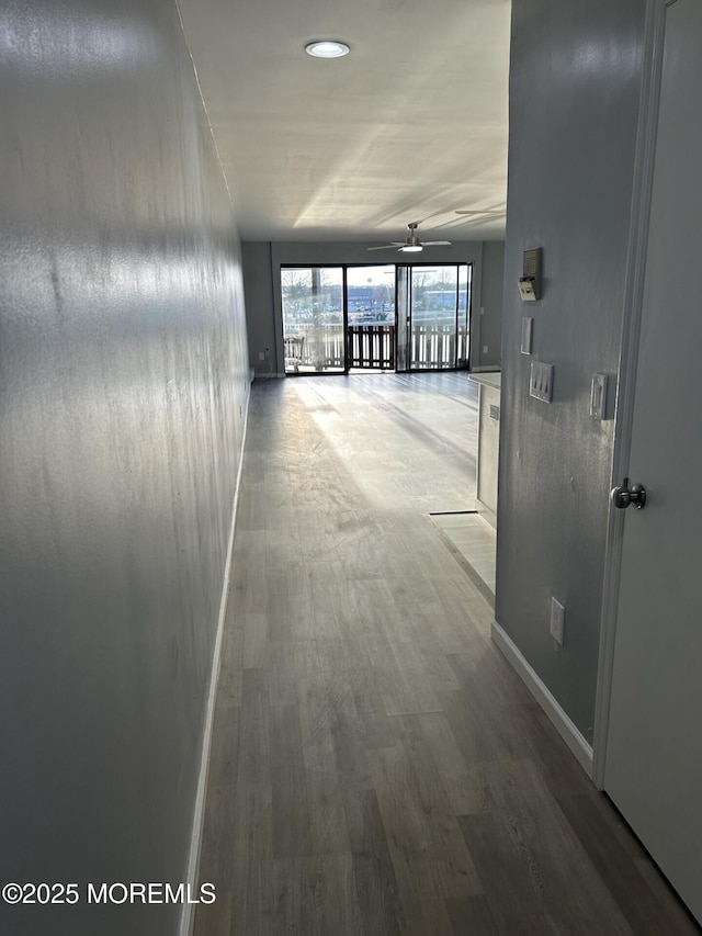 hall featuring baseboards