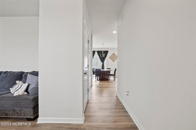 hallway with recessed lighting, wood finished floors, and baseboards
