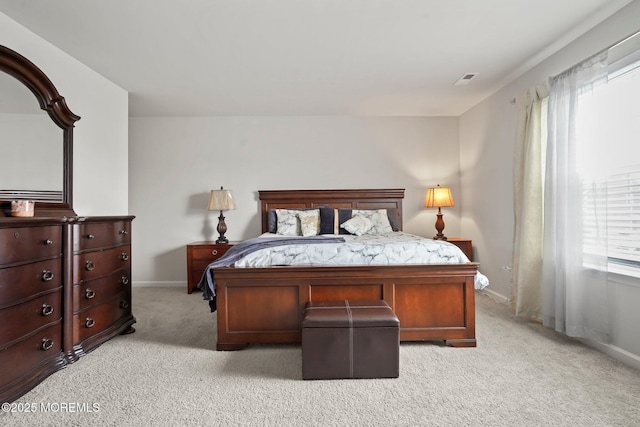 bedroom featuring visible vents, baseboards, and light colored carpet