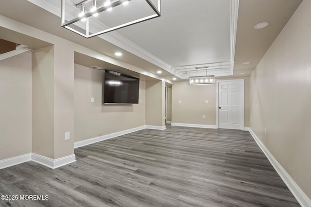 below grade area with baseboards, crown molding, wood finished floors, and recessed lighting