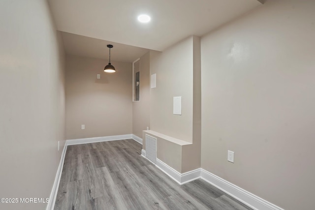 interior space featuring baseboards, visible vents, and light wood-type flooring