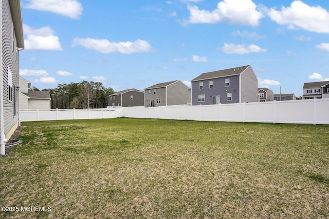 view of yard with fence and a residential view