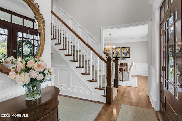 15 Monmouth Ave, Rumson, NJ 07760 - foyer featuring a decorative wall, a chandelier, stairway, wood finished floors, and french doors