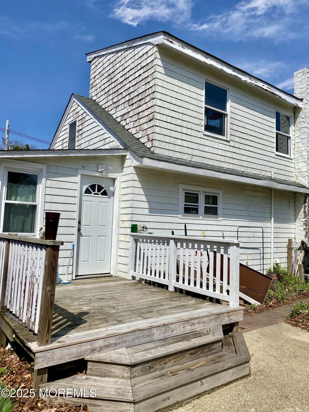 rear view of house with a wooden deck