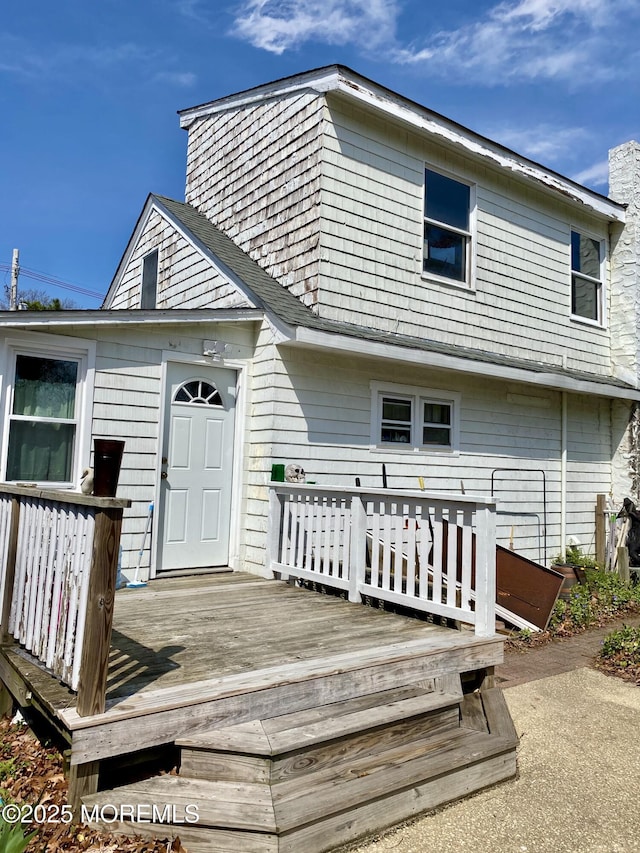 rear view of house with a wooden deck