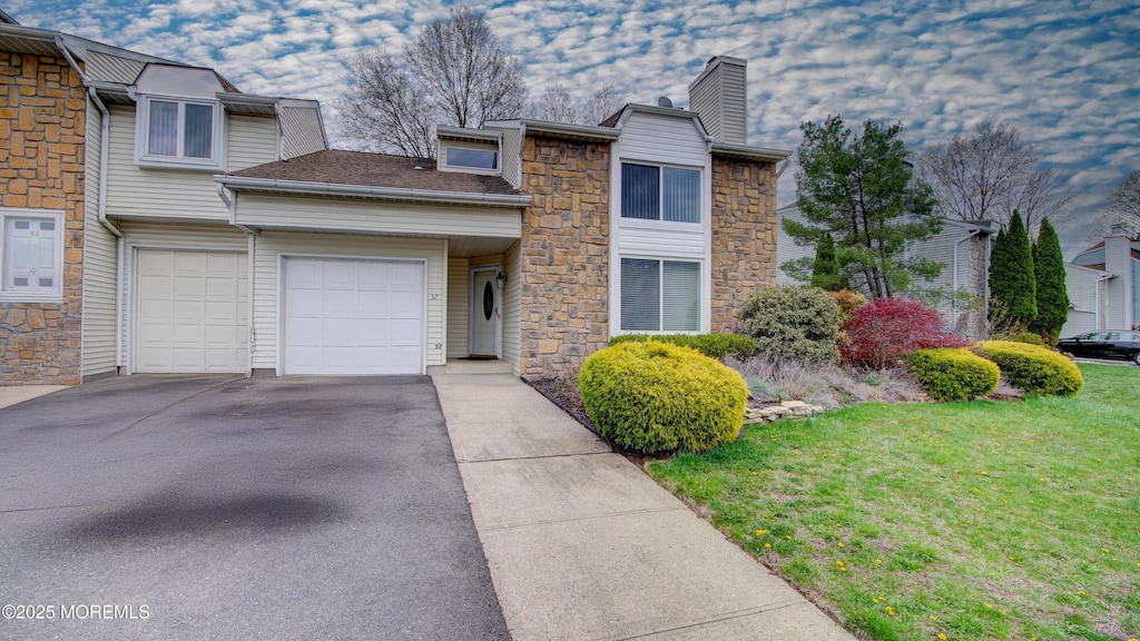 57 Allison Rd, East Windsor, NJ 08520 - view of front of home featuring a front yard, stone siding, an attached garage, a chimney, and driveway
