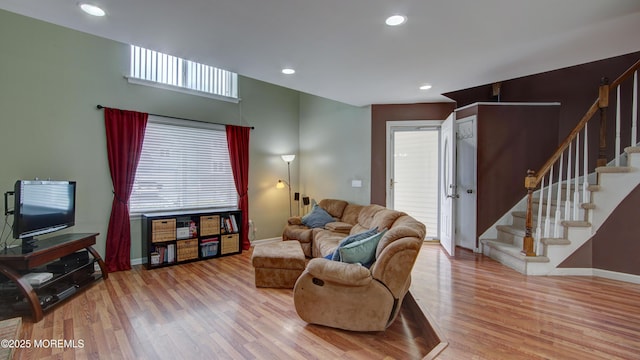 living room with baseboards, recessed lighting, wood finished floors, and stairs
