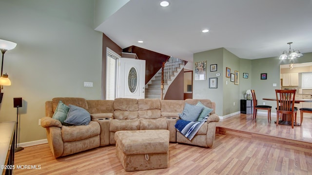 living room with recessed lighting, stairs, light wood-type flooring, and baseboards