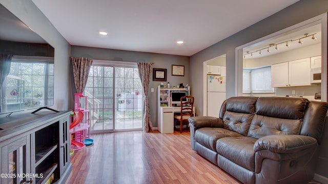 living room with light wood-style floors and recessed lighting