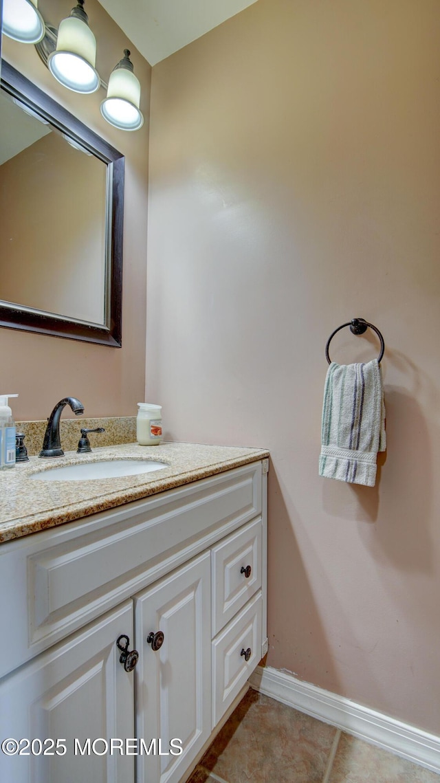bathroom featuring tile patterned floors, vanity, and baseboards