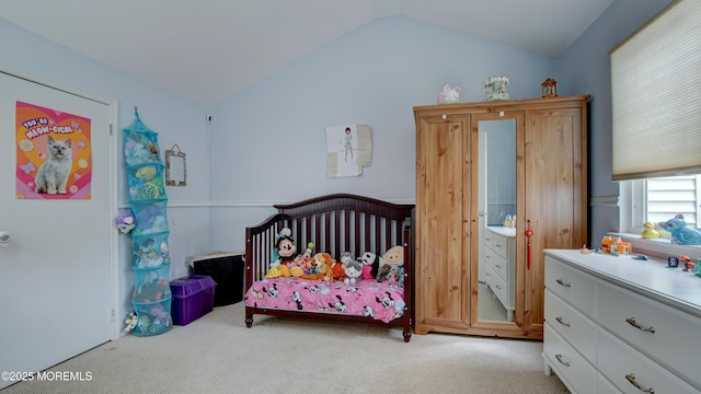 carpeted bedroom with lofted ceiling