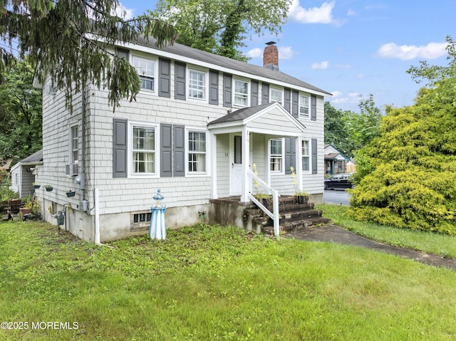 14 S Holmdel Rd, Holmdel, NJ 07733 - colonial inspired home featuring a front lawn, a chimney, and roof with shingles