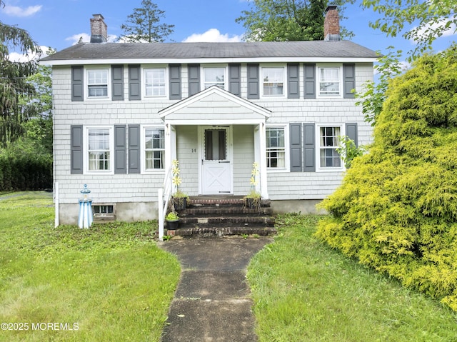 14 S Holmdel Rd, Holmdel, NJ 07733 - colonial home featuring a chimney, entry steps, a shingled roof, and a front yard